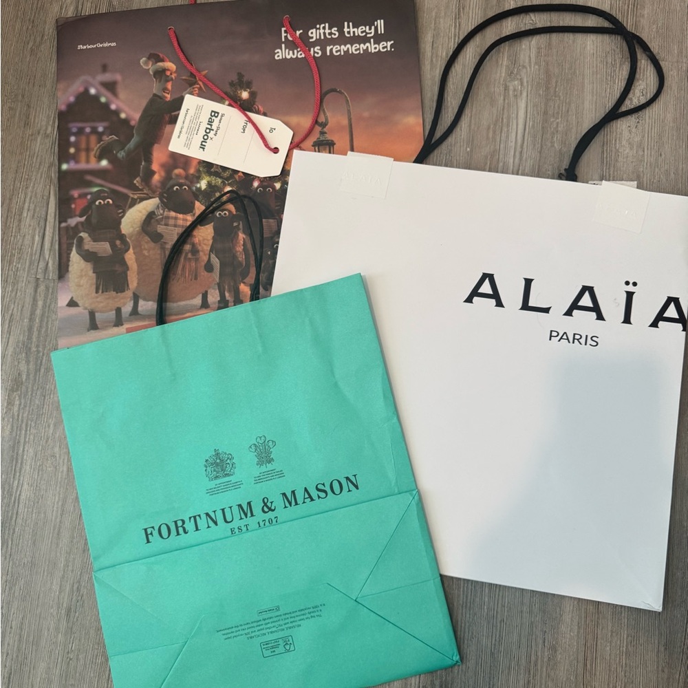 Alaia, Barbour, and Fortnum & Mason empty shopping bags, as is